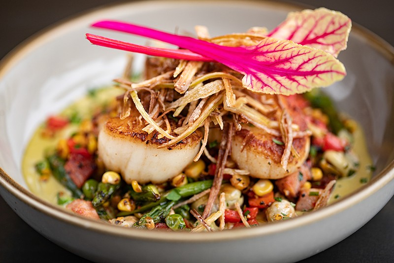 The pan seared scallops include avocado butter cream, pork belly and more.