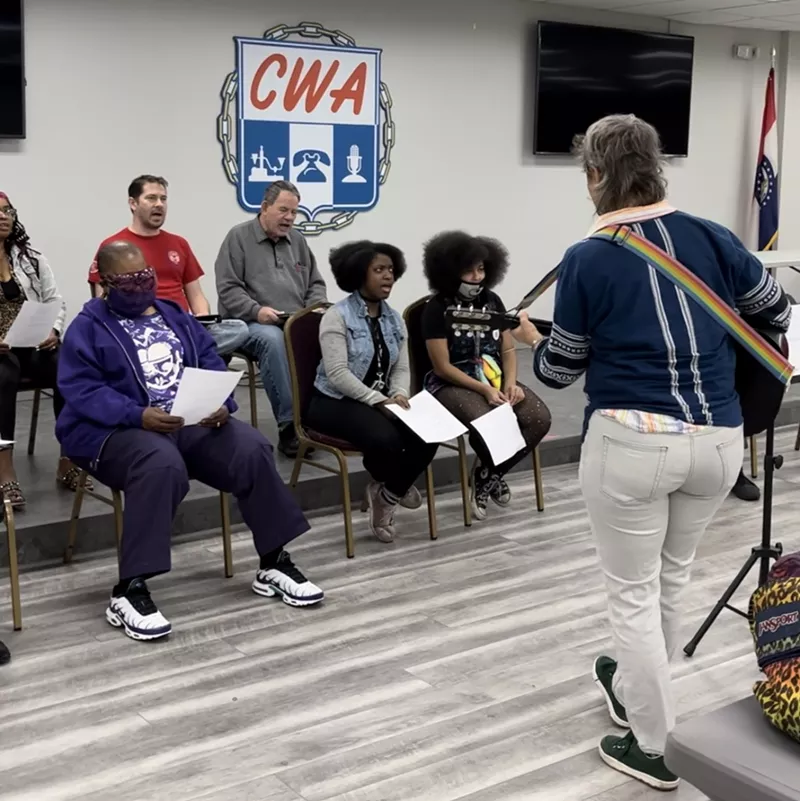 The cast of The Workers' Opera: Blue Light Special includes several current Amazon workers, shown in rehearsal with musician Celia. - COURTESY OF BREAD AND ROSES MISSOURI