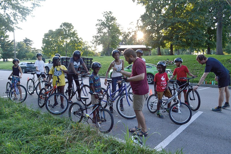 A group of Earn-A Bike students perform safety checks during a summer class in Forest Park.