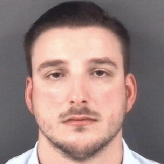 Booking photo of 26-year-old former police officer Samuel Davis