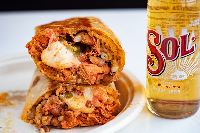 The tinga burrito includes shredded chicken and chorizo with grilled onions in chipotle sauce.