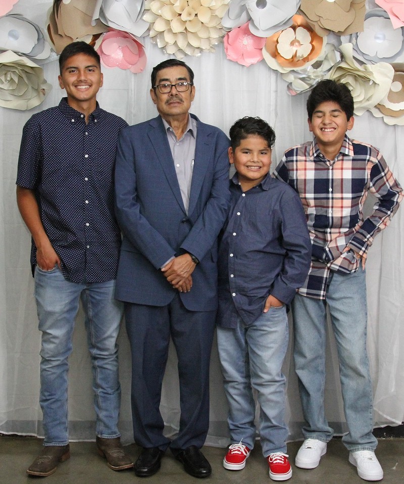 The author, far left, with his beloved abuelito and two younger brothers. - COURTESY OF JULIAN TREJO