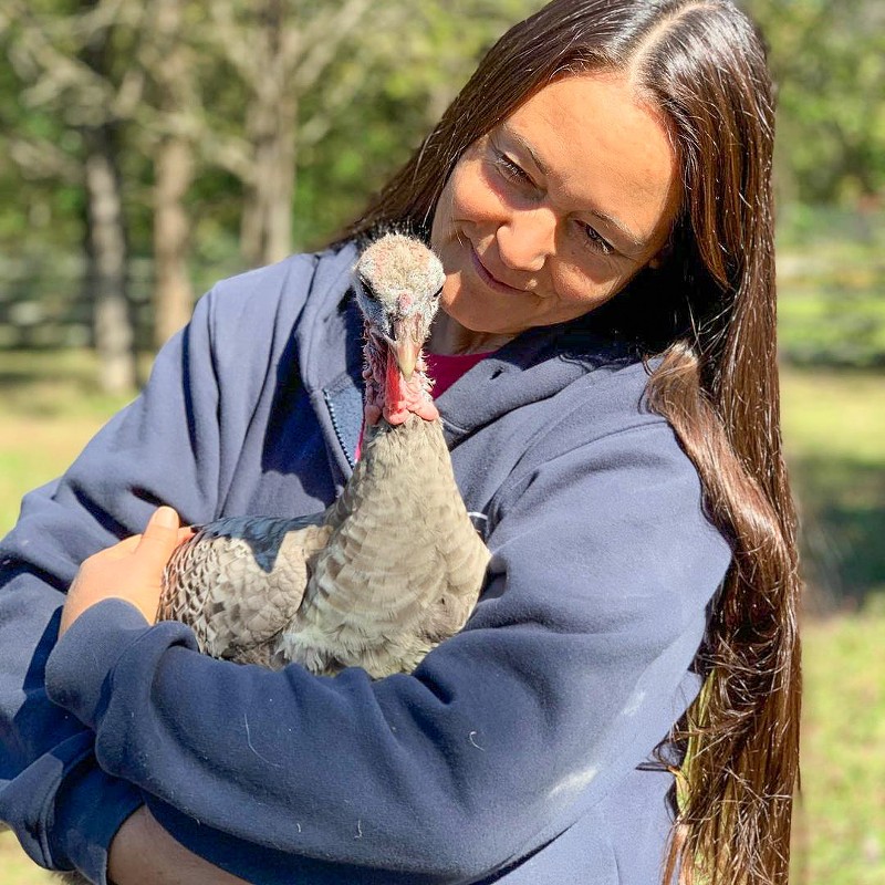 Ellie Laks with a turkey friend. - COURTSY OF THE GENTLE BARN