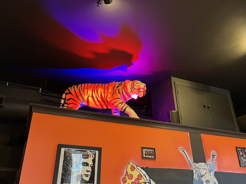 A tiger glows over the back space.