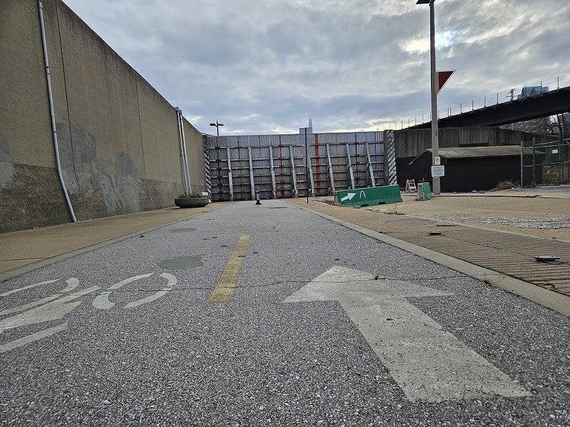 The very top of the Gateway Arch is visible over a closed floodgate on the northern end of the Arch grounds. The closed floodgate blocks access along the Riverfront Trail, and has now for years. Confusing detours often lead to blocked streets near surrounding casino facilities, along with unmanageably steep hills that effectively eliminate the trail as an option for many would-be users. - EVIE HEMPHILL