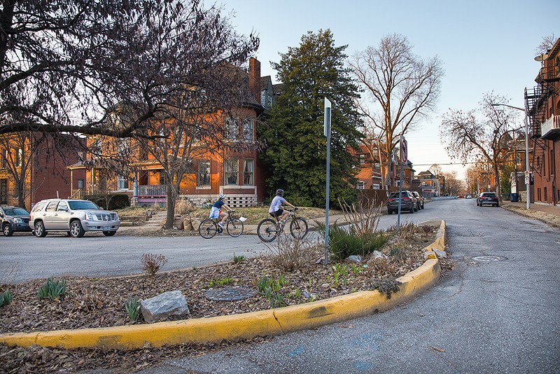 Bikers ride by a traffic calming device at the intersection of South Spring Avenue and Russell Boulevard on Monday, Feb. 26, 2024, in the Shaw neighborhood. (Zachary Linhares)