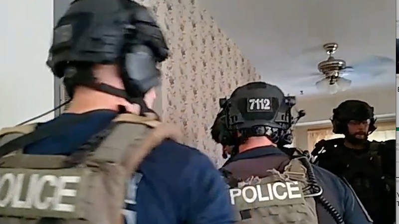 Still from body cam footage of officers entering Ferguson home.