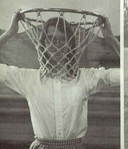 Jane Smiley's high school yearbook photo. In Lucky, Jodie recalls of a classmate, "The gawky girl had stuck her head into a basketball basket, taken hold of the rim, and her caption was, 'They always have the tall girls guard the basket.'" - VIA THE SCHOOL YEARBOOK
