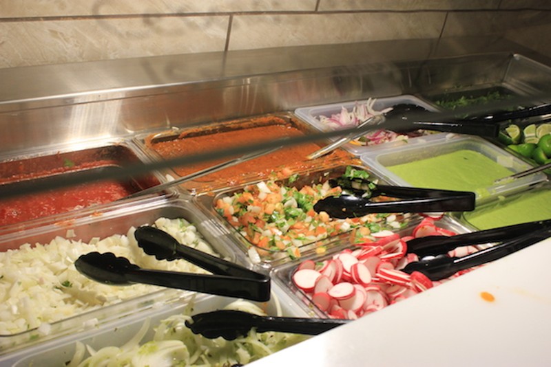 The salsa bar is unusually extensive, with a host of toppings, including fresh vegetables and limes. - PHOTO BY SARAH FENSKE