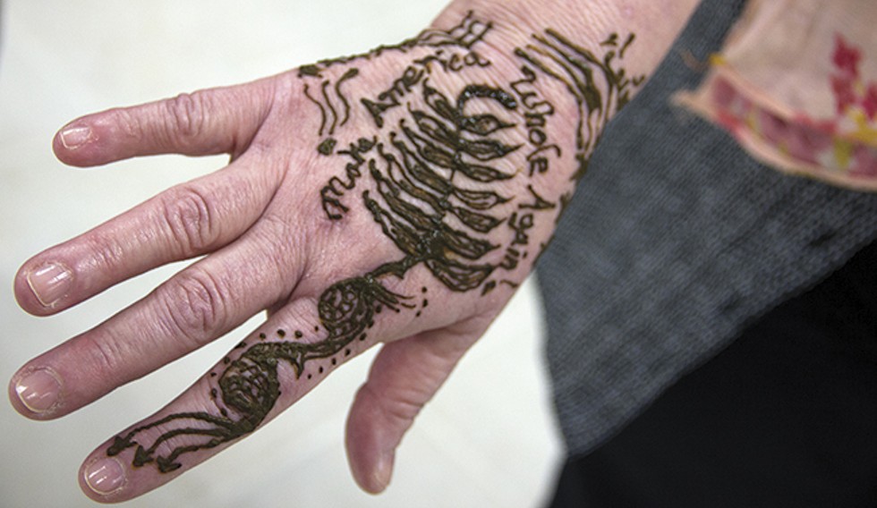At CAIR's open house, visitors could get henna tattoos, like this one urging people to "Make America Whole Again." - PHOTO BY DANNY WICENTOWSKI