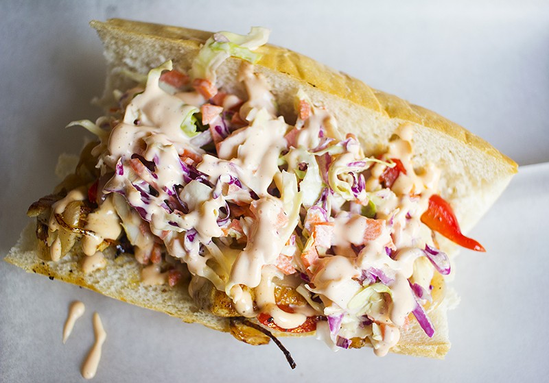 The chicken sandwich is topped with grilled red peppers, cole slaw and housemade hot-sauce aioli on a Vitale's baguette. - PHOTO BY MABEL SUEN