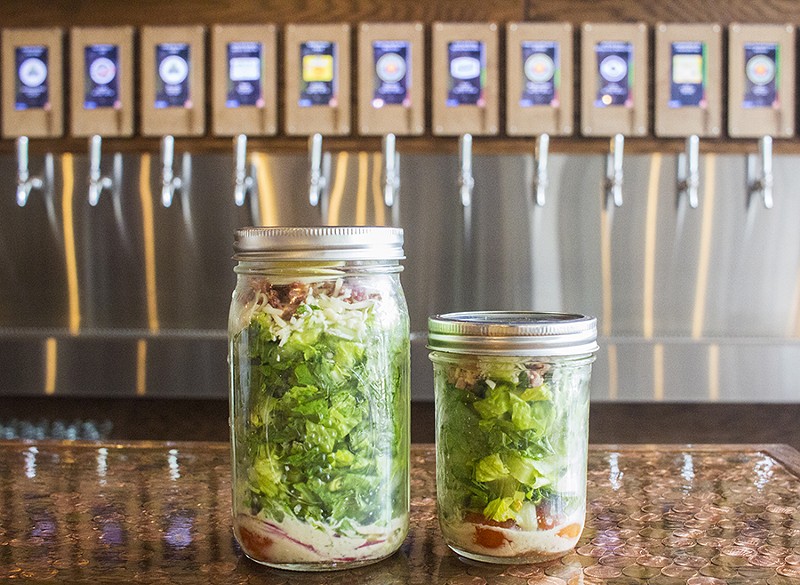 he "Tapped Mason Jar Salad" comes in two sizes with romaine lettuce, bacon, egg, red onion, tomato, a four-cheese blend and house vinaigrette. - PHOTO BY MABEL SUEN