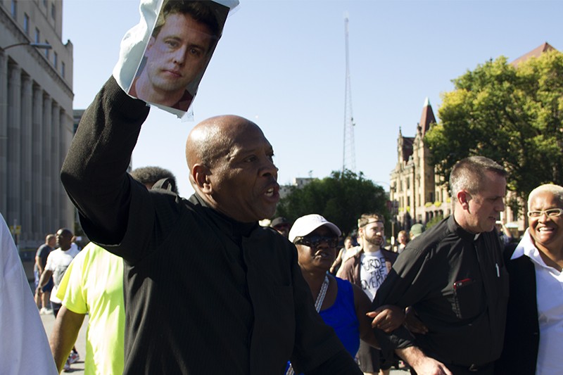 Activist Anthony Shahid brandishes a puppet with the face of former St. Louis cop Jason Stockley. - PHOTO BY DANNY WICENTOWSKI