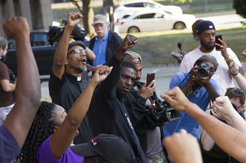 State Representative Bruce Franks Jr. leads protesters in a chant on the steps of St. Louis City Hall. - PHOTO BY DANNY WICENTOWSKI