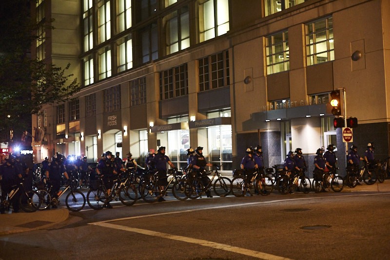 Cops gather outside police headquarters on Sunday, September 17. - PHOTO BY THEO WELLING