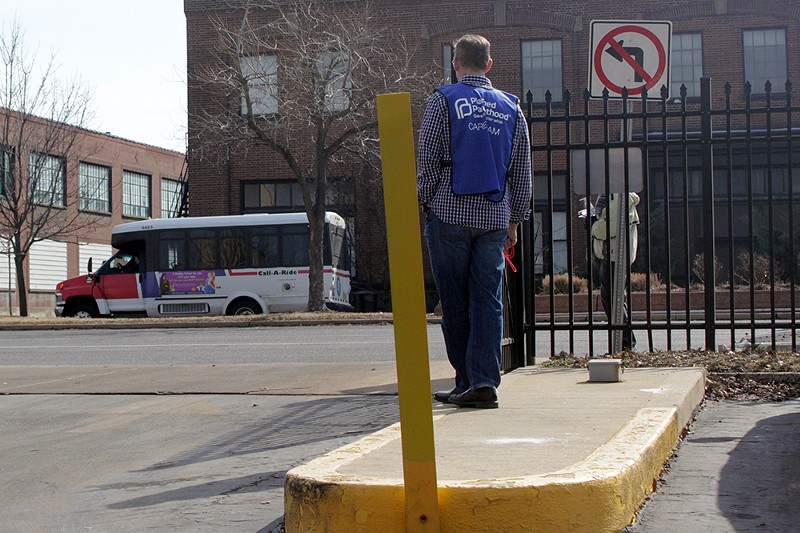 A Planned Parenthood volunteer stands at the entrance of the clinic in the Central West End. - PHOTO BY DANNY WICENTOWSKI