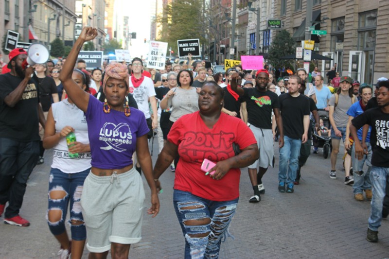 Melissa McKinnies (left) and Ebony Williams lead protesters along Washington Avenue. - PHOTO BY DOYLE MURPHY