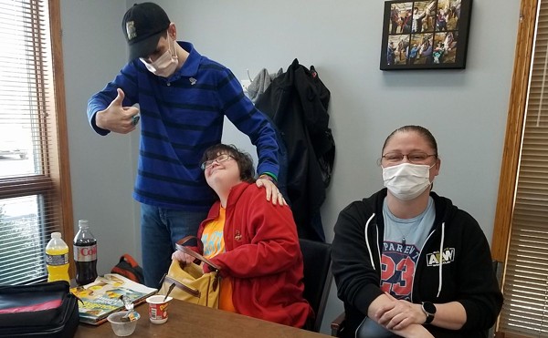 Community Opportunities clients David, left, and Megan, enjoy a moment with community skills teacher Kristin Nobus, right, at the agency's day program in Troy.