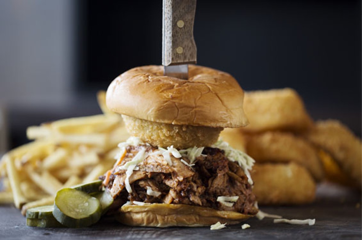 The "Big Andy" is a brisket, turkey, pork and chicken sandwich that's topped with slaw and a dipped onion ring. It is served on a toasted sweet Hawaiian roll, and here it's shown onion rings and fries.
    
    
    See photos: WildSmoke Serves Delicious Barbeque Staples in Creve Coeur