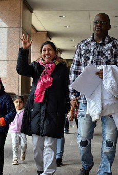 Ilsa Guzman-Fajardo (center) leaves the Robert A. Young Federal Building with her family and (far right) attorney, Javad Khazaeli.