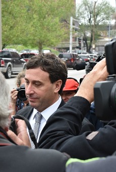Ex-St. Louis County Executive Steve Stenger makes his way through reporters after pleading guilty to federal felonies.