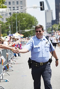 A police officer marches in the 2019 Pride St. Louis parade.