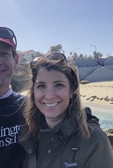 Jeffrey Davis and his wife, Tasha, watch harbor seals on a beach in San Diego.