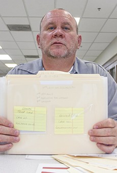 Timothy Prosser, shown here in 2016 with a collection of his legal files, is the only prisoner in Missouri serving a life sentence for drug charges.
