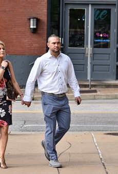Dustin Boone, right, walks to the federal courthouse in St. Louis with his family.