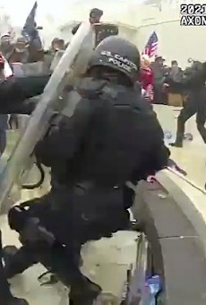 Rioters knock a police officer to the ground on January 6, 2021, at the U.S. Capitol, as captured on a police body cam.