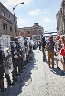 Protesters face off in downtown St. Louis yesterday after the acquittal of a former city cop.