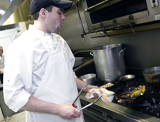 Mike cooking up the veggies for the Newman Pork Chop. See more photos from Molly's in our slideshow. - PHOTO: STEVE TRUESDELL