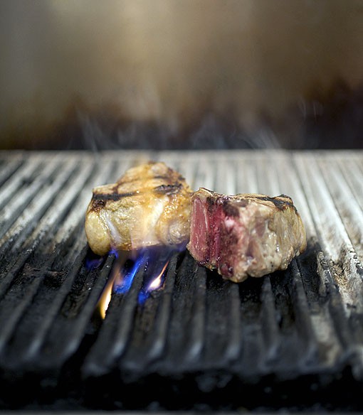Executive Chef John Buchanan's lamb porterhouse on the grill. He tells me it's a very original cut of meat. He likes taking a classic dish and making it more contemporary. See a slideshow of Table Three photos here. - PHOTO: JENNIFER SILVERBERG