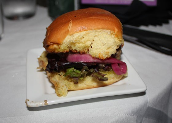 The tempeh slider, with house-made tempeh, spicy African harissa sauce, pickled red onion and oumou spread on a house-made herb-buttered wheat roll. | Nancy Stiles