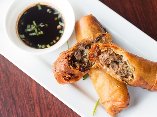 "Mom's Spring Rolls" stuffed with ground beef and veggies, served with soy dipping sauce.