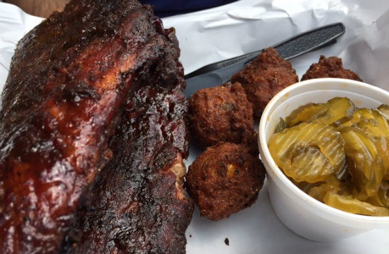 Dalie's full rack of ribs, shown here with a side of hush puppies and "Fire and Ice Pickles" - PHOTO BY SARAH FENSKE