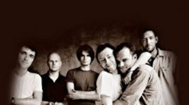 The dude about to get noogied by Thom Yorke is Nigel Godrich, the long-time producer of Radiohead. Godrich recently formed Ultraista, a side-band from his usual producing duties.