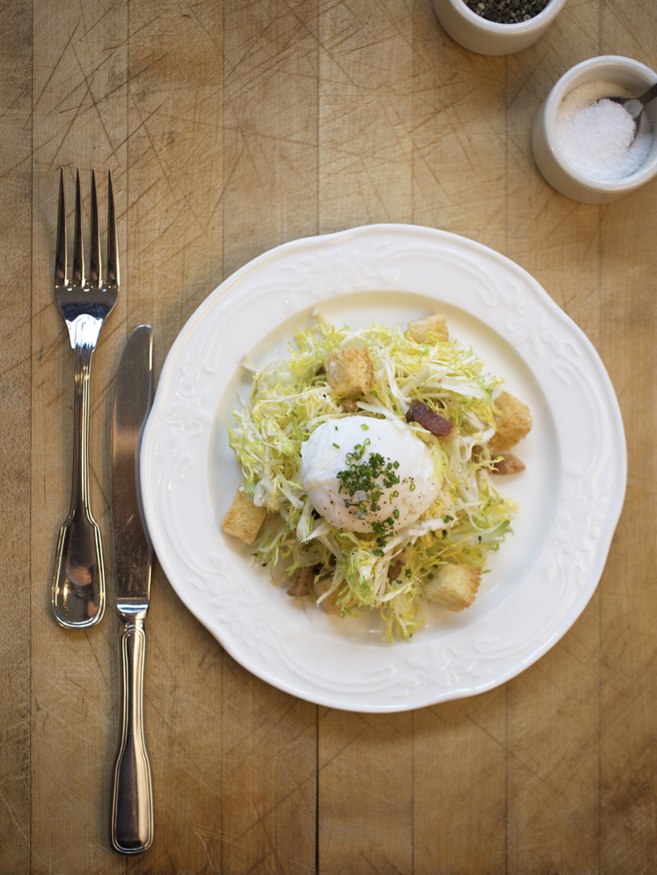 One of the salads, the fris&eacute;e & bacon. Served with a poached egg & bacon vinaigrette.