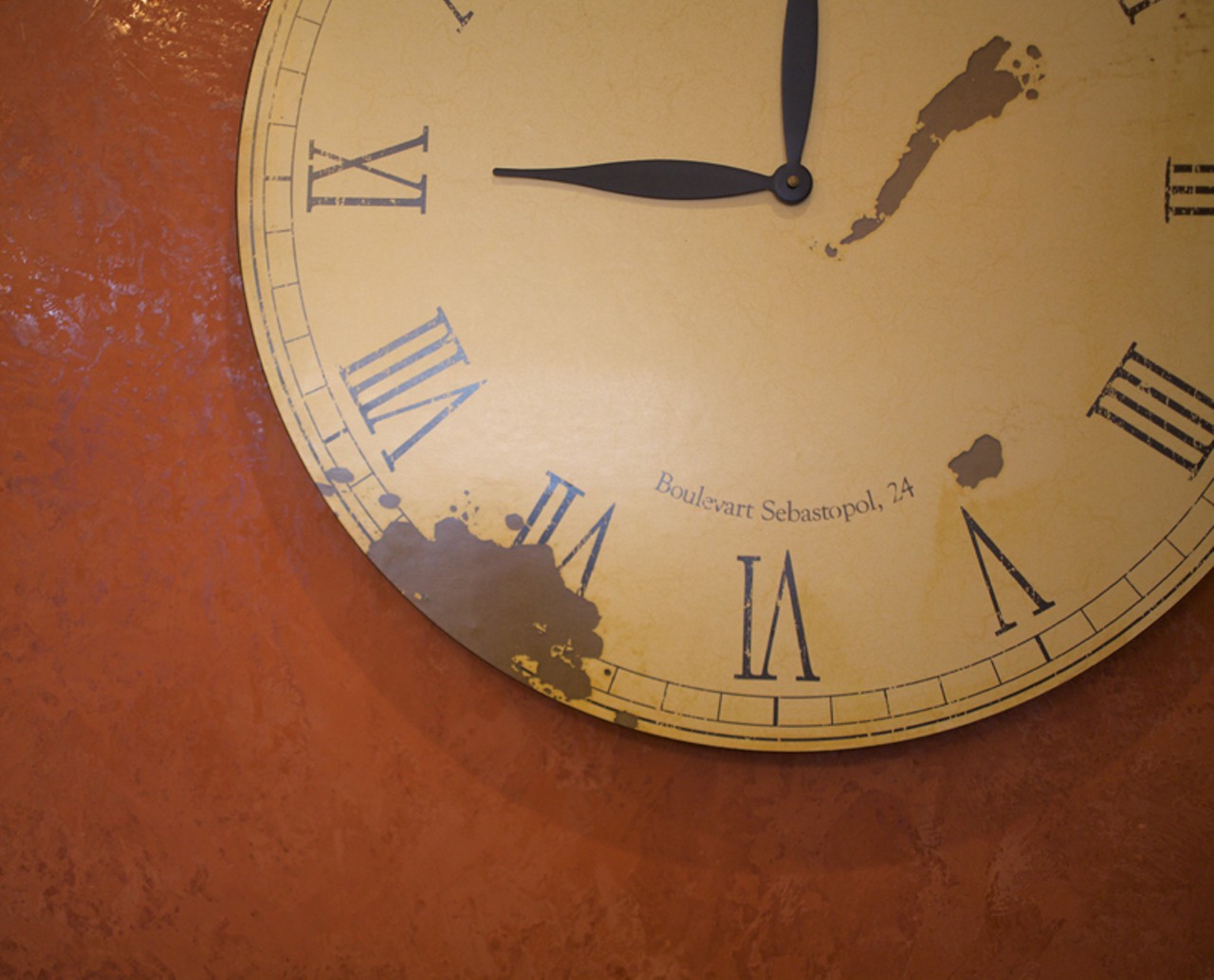 The clock on the richly colored back wall.