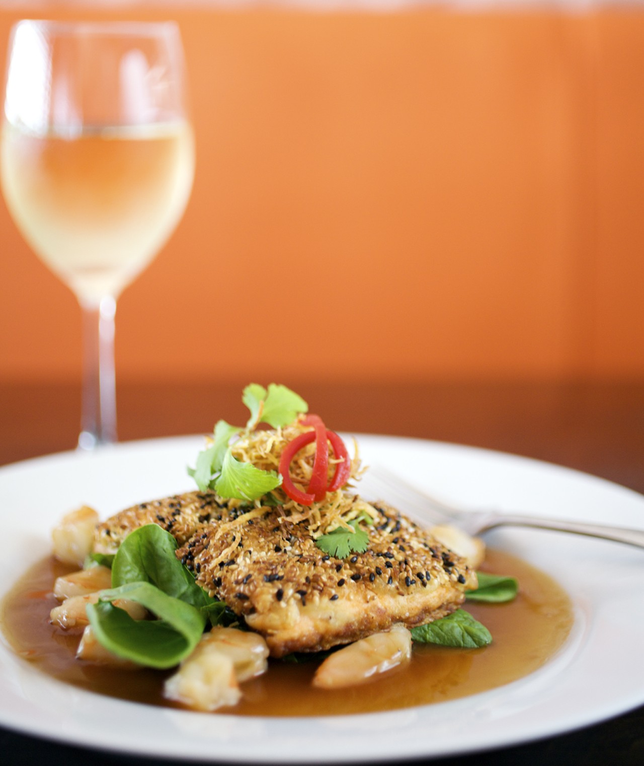 Crispy sesame-crusted salmon is served with fresh seasonal vegetables and chopped shrimp in an Asain Island sauce.