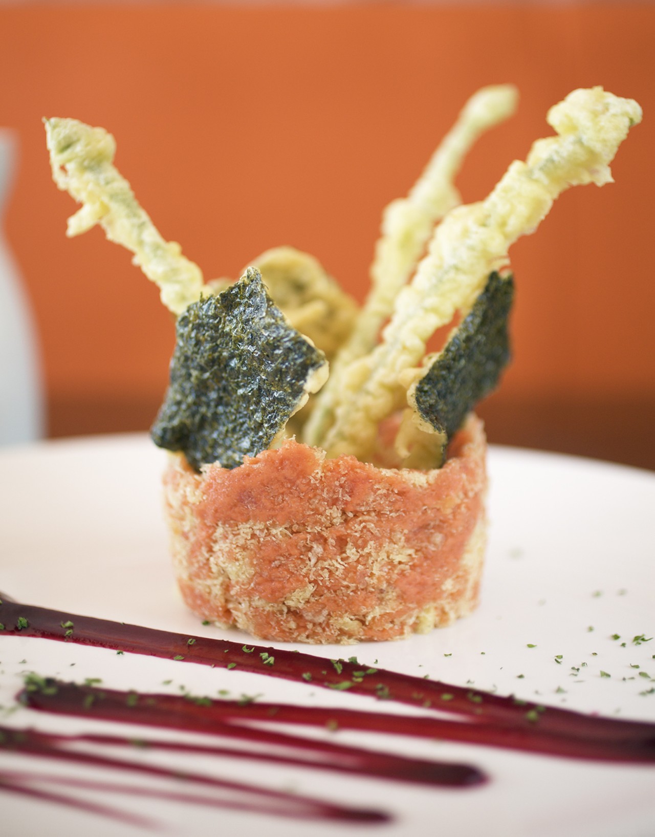 The Crunchy Tuna Tower is mashed spicy tuna with Wasabi cracker and tempura chive flower.