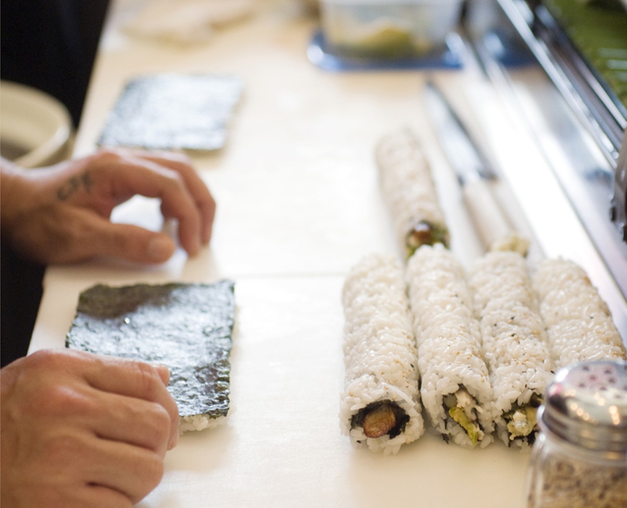 Preparing sushi rolls.