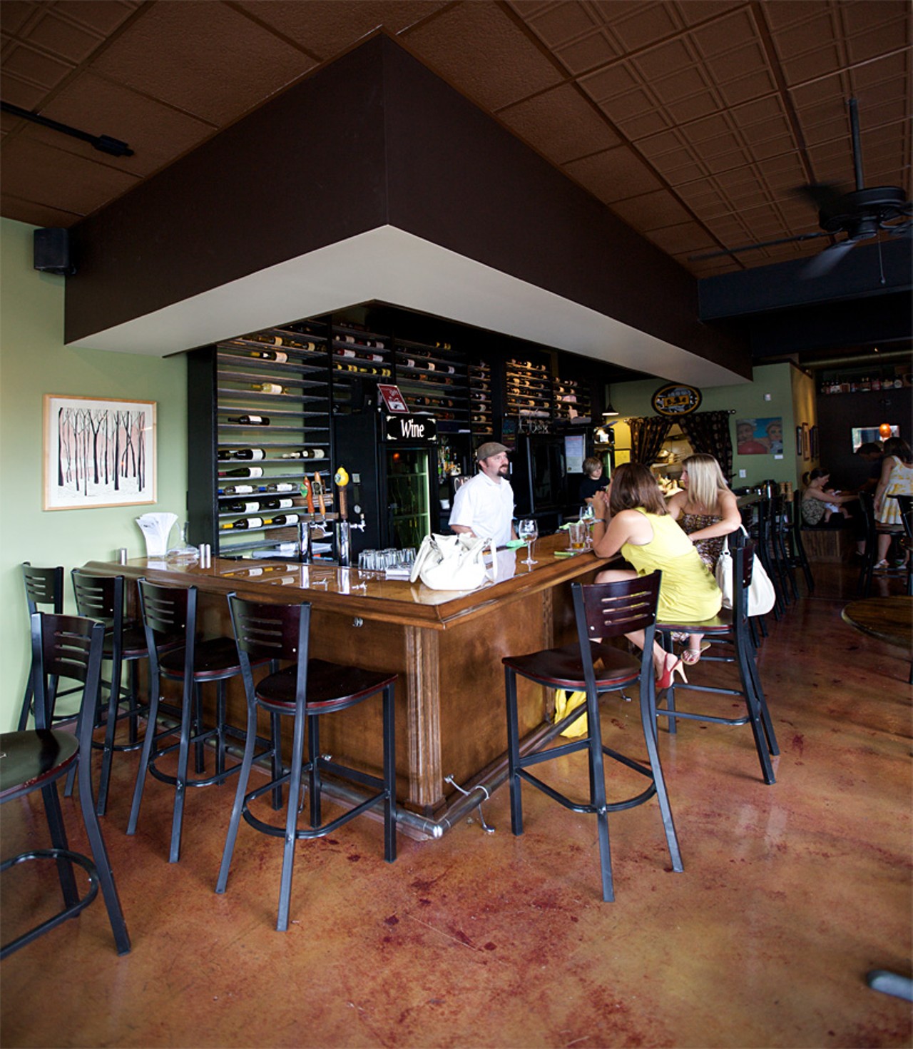 Inside Cork Wine Bar, owner Mike Lonero chats with customers from behind the bar.