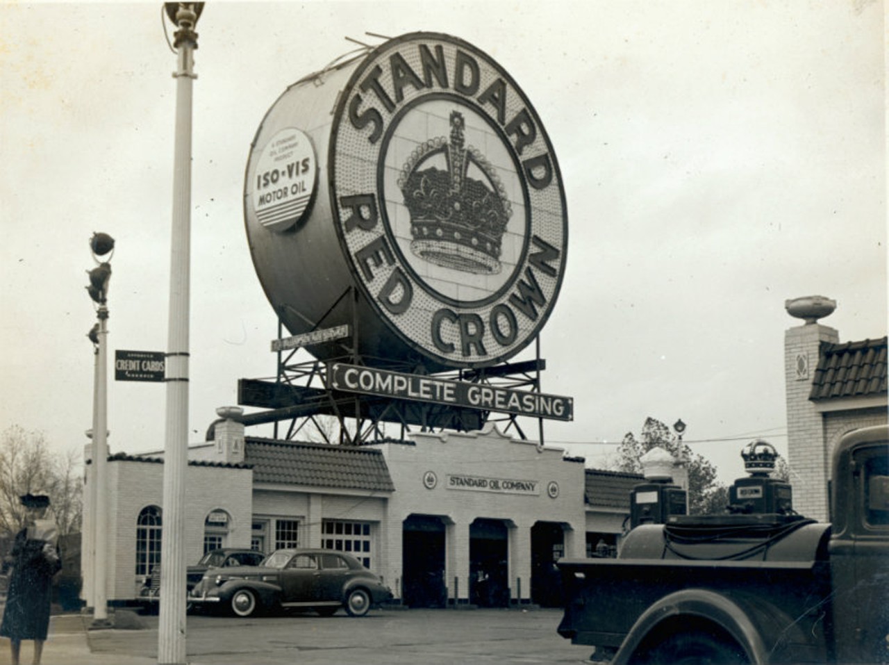 Use the Standard Red Crown sign as a landmark.
Anyone who has driven west from downtown St. Louis on Highway 40 or east on Clayton Road knows the &#147;big Amoco sign."  Sitting atop Stevenson&#146;s Hi-Point Service & Wash, the Amoco sign has been directing St. Louis drivers for more than fifty years. But many can still recall the original &#147;big sign&#148; that once stood tall at that intersection. Erected in 1932, the Standard Red Crown sign weighed more than forty tons and contained 5,800 light bulbs. Dismantled in 1959 when Standard Oil built a new station and a new forty-foot sign on the site. Later renamed an Amoco station, the sign was modified to its current state. Photo courtesy of the Missouri History Museum, St. Louis.