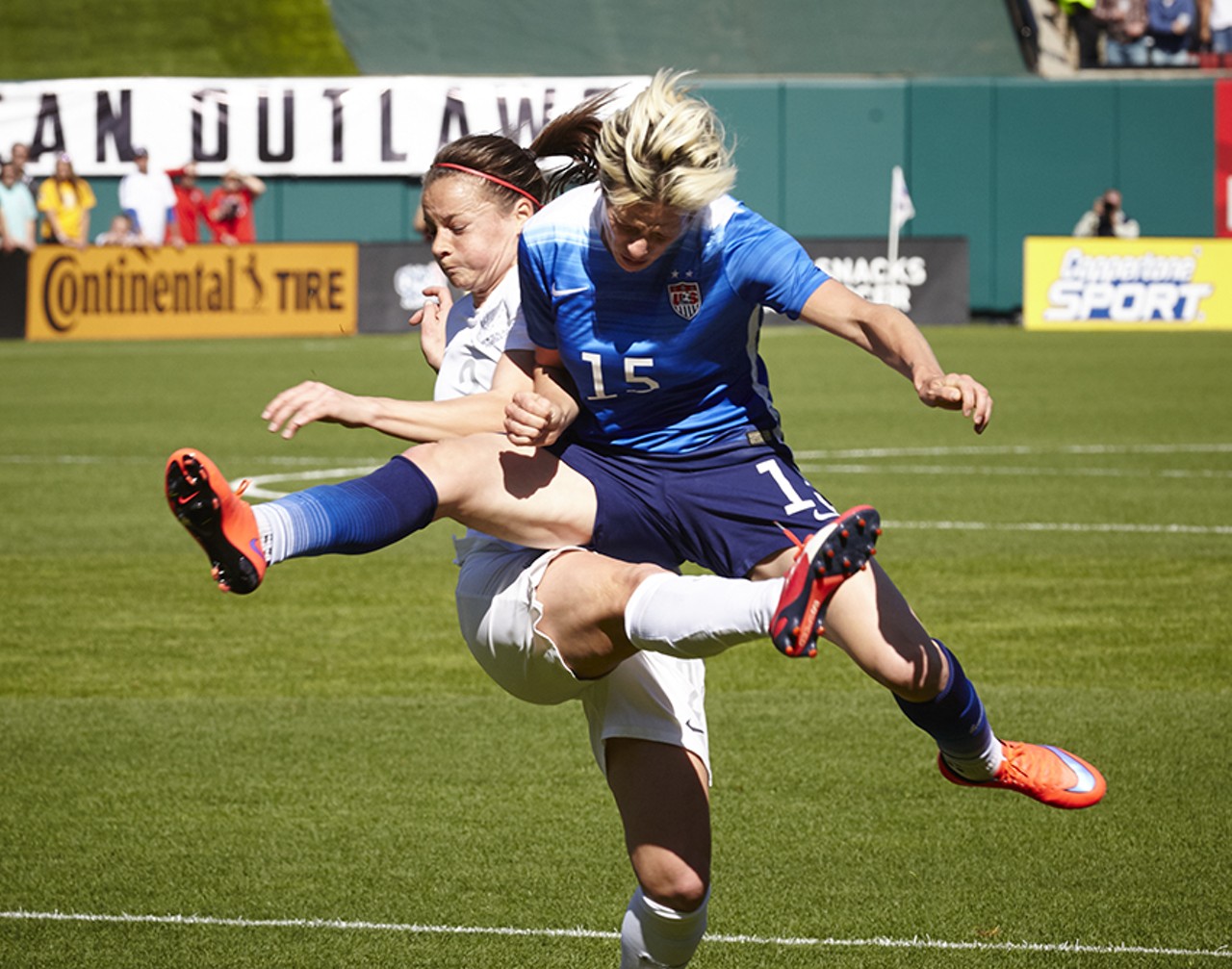 Rapinoe in a mid-air collisiion to end her break away.