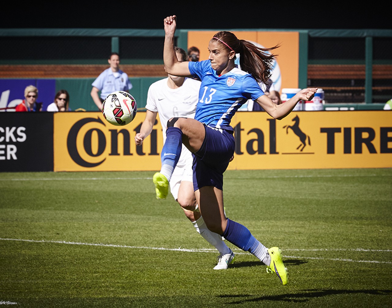 Alex Morgan volleys the ball for a shot on goal.