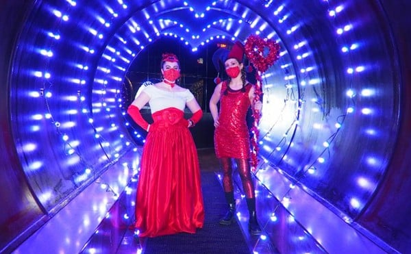 Two women stand in the Tunnel of Love.