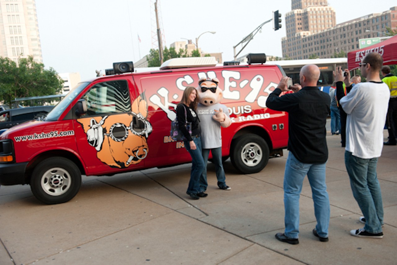 A concert attendee poses with the KSHE Pig outside Scottrade Center before Van Halen's show