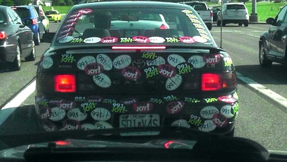 He has a Joy FM sticker on his car.