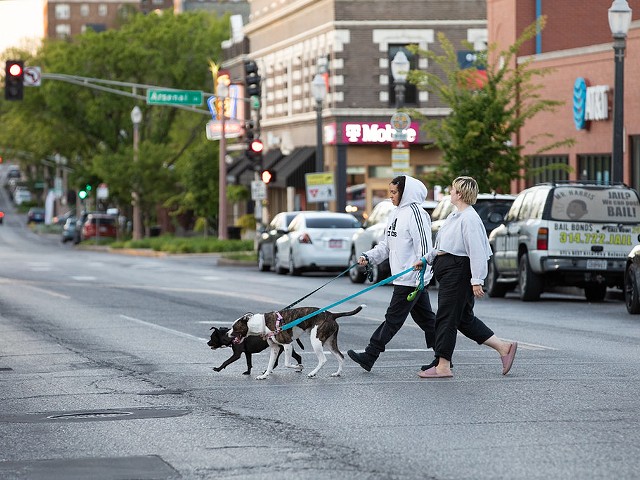 People cross South Grand Boulevard. Author Liz Chiarello has learned the hard way that motorists make the street unsafe for many pedestrians.